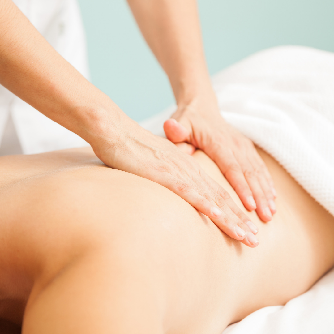 image shows a back being massaged with a white towel over the lower back on a blue background