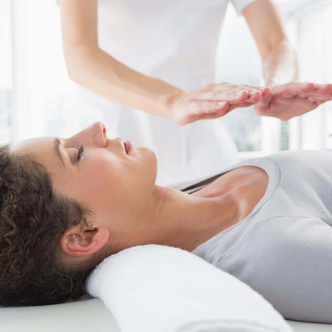 Image of woman receiving reiki whilst laying down