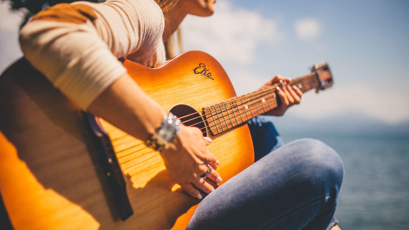 image of a woman playing a classical guitar