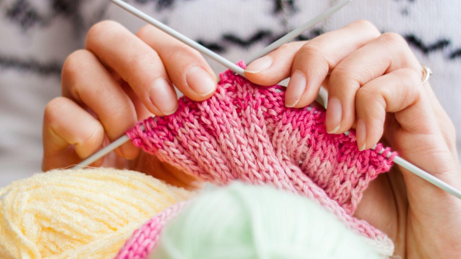 overcome stress image of woman knitting a pink scarf