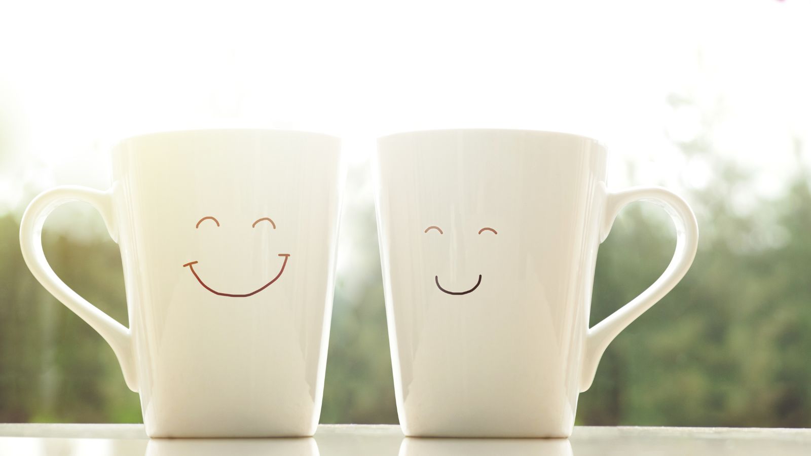 how to have a happy and healthy new year. Image of two white mugs smiling