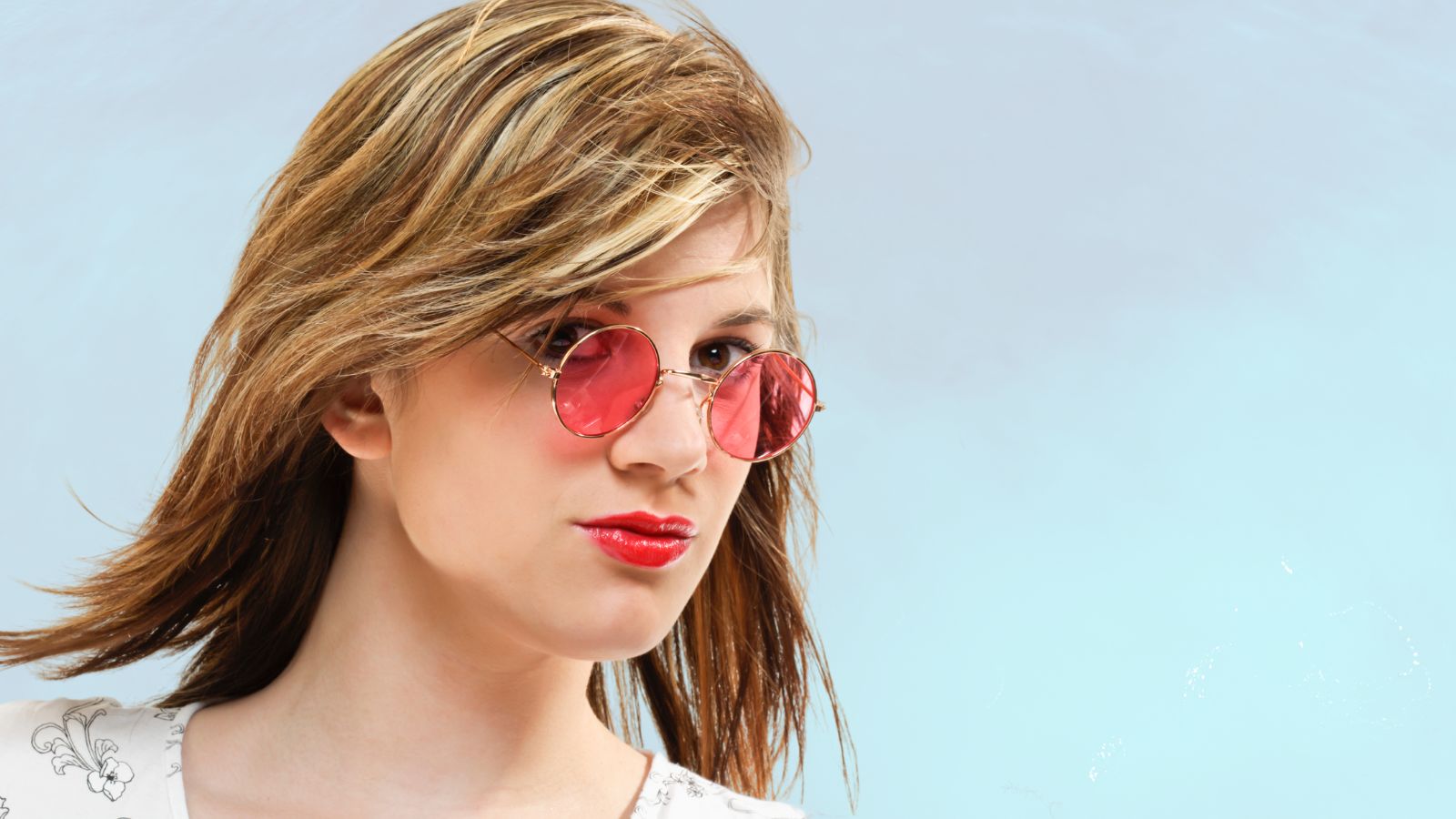 how to improve your self esteem see yourself with kind eyes. Image of woman wearing rose tinted glasses on a blue background