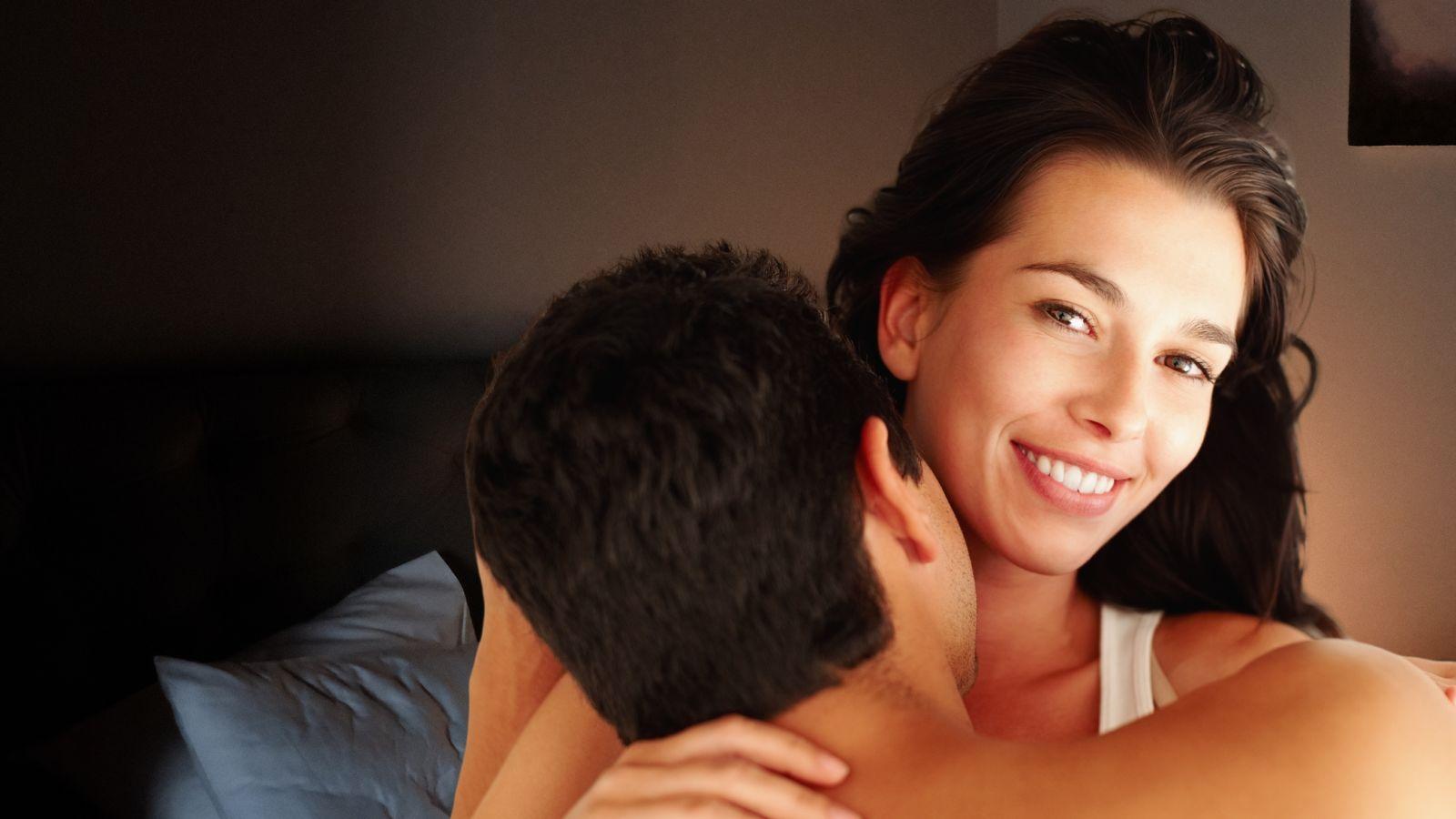 loss of libido rebuilding intimacy, couple in bed on cosy brown background
