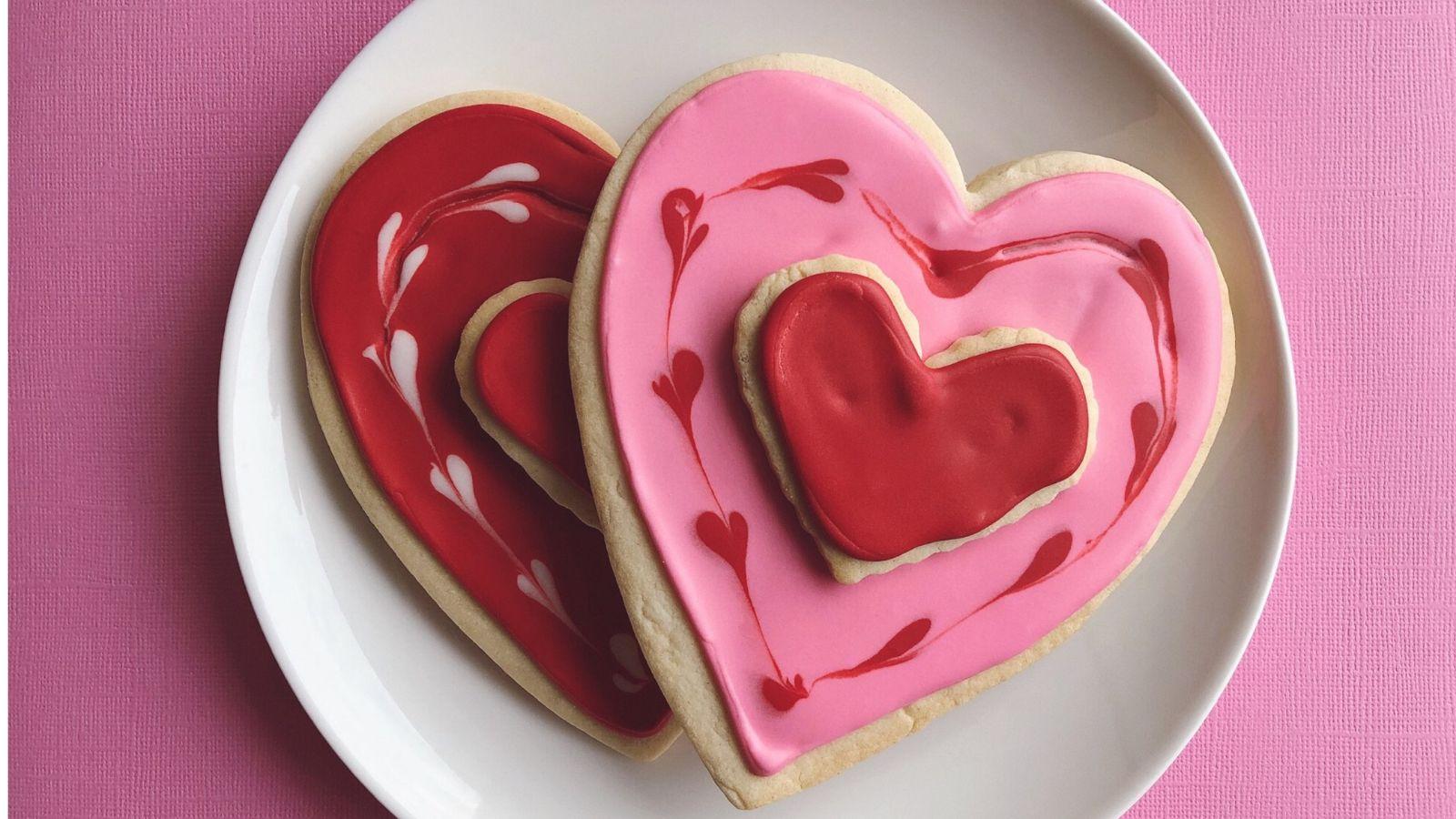 Loss of libido in menopause Loss of libido in menopause image of two love heart shaped biscuits with love heart icing on a white plate on a hot pink background