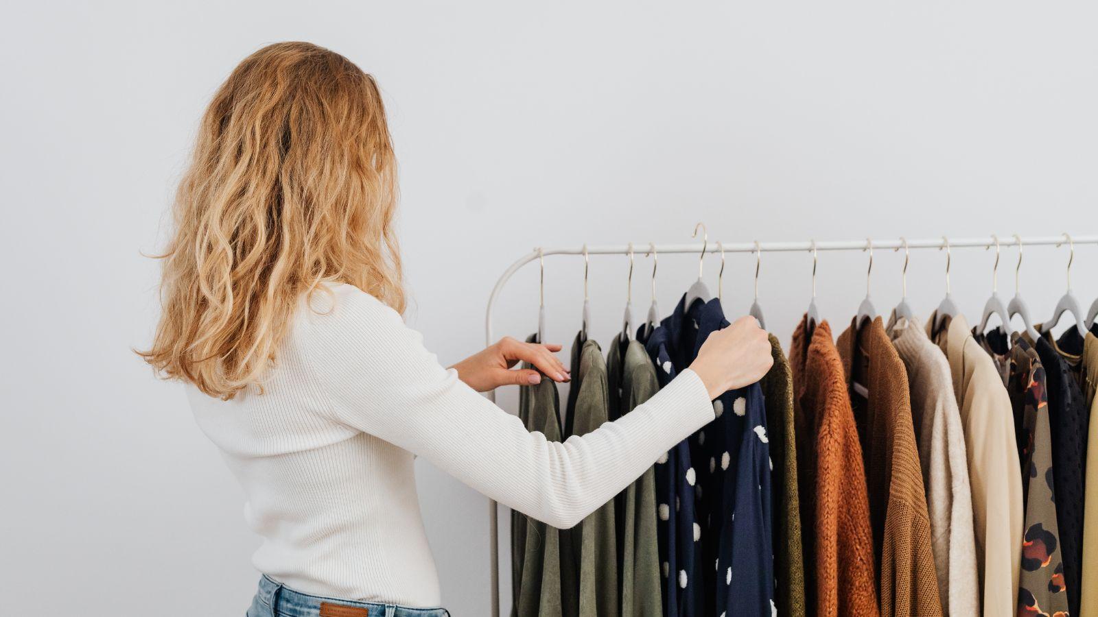 Sunday reset image of a blonde haired lady sorting out her outfits for the week