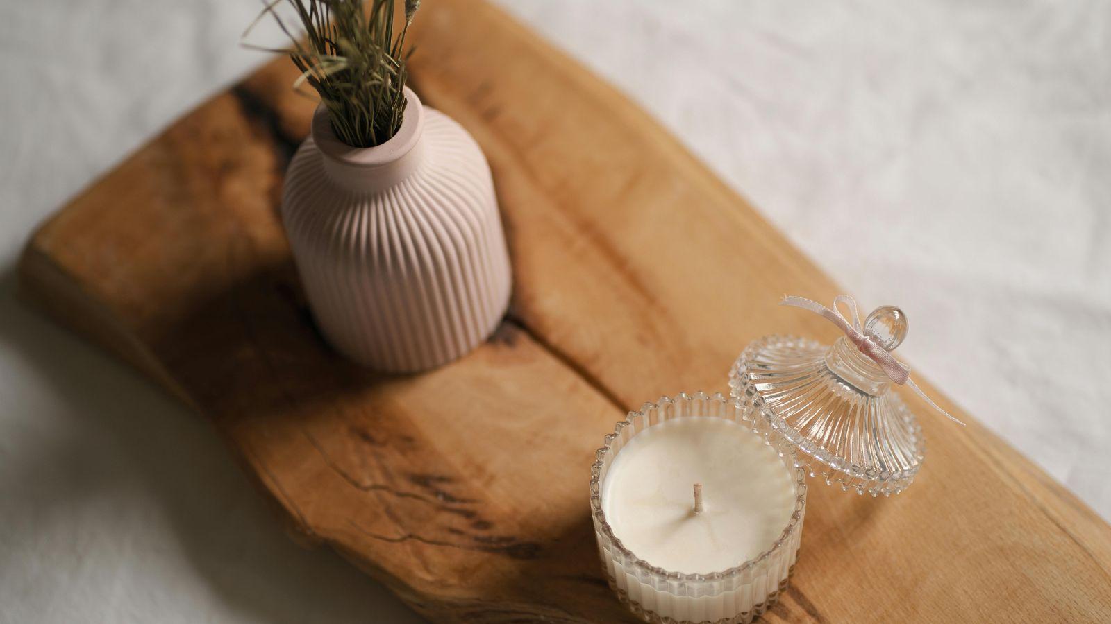 Raise your home's vibration by reducing visual clutter image of a  piece of wood with a candle on it 